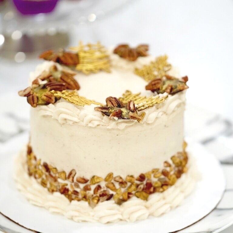 Custom cake with pecans and gold leaf
